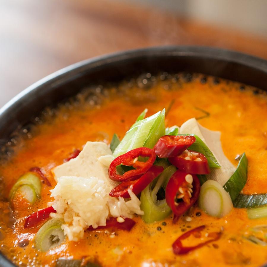 Soft-tofu stew topped with egg, scallion and chili