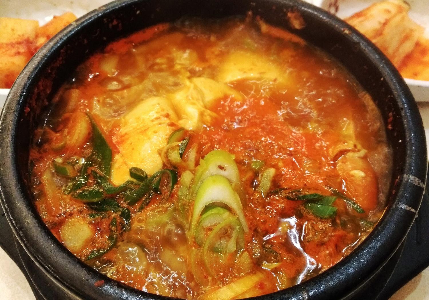 A stone pot of Korean soft-tofu stew, bubbling
